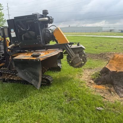 Stump grinder grinding a stump down to soil level in Central Indiana